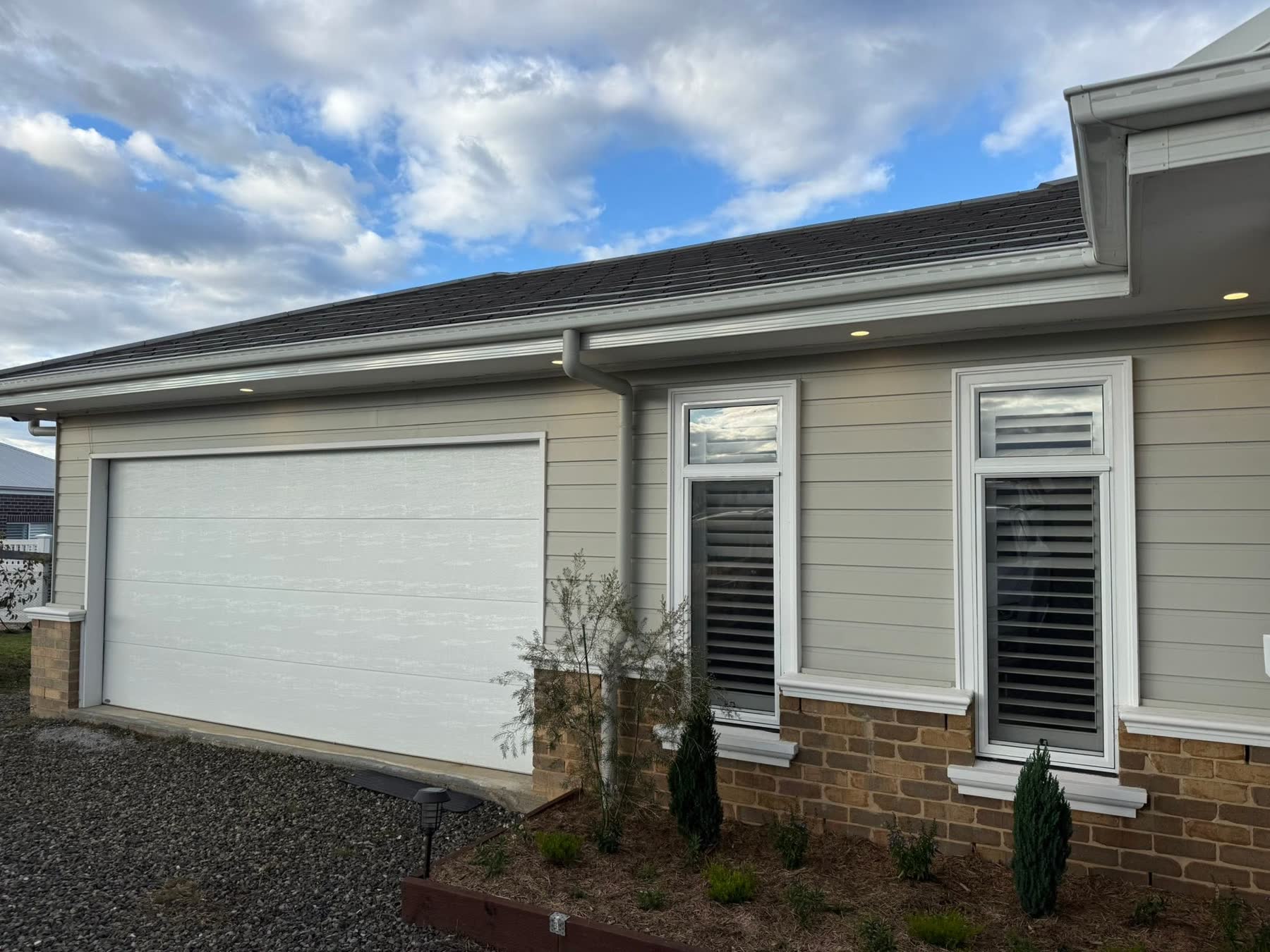 Recessed eave downlighting along a Newcastle home exterior